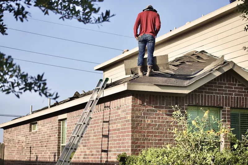Professional roofer working on a residential roof in Stowe